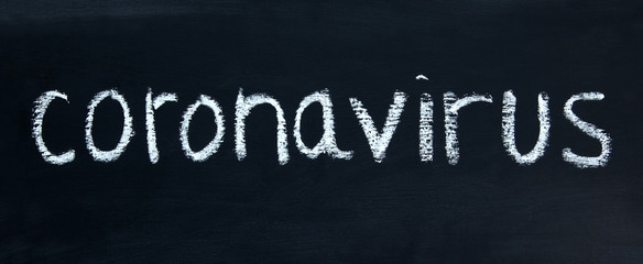 Coronavirus COVID-19 - sign for the virus in real chalk letters - panorama / header / banner.