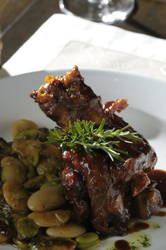 Roasted Boar Stinco with beans and broad beans..