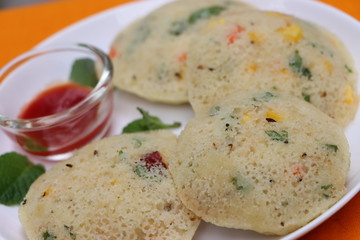 Rawa Idli or rava idli or vegetable Idli, Steamed semolina and vegetable cake served with chutney, south Indian food 