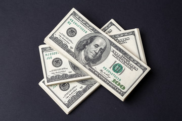 Cash of hundred dollar bills, dollar background.