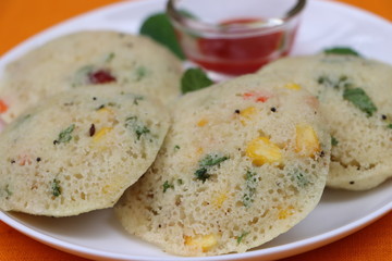 Rawa Idli or rava idli or vegetable Idli, Steamed semolina and vegetable cake served with chutney, south Indian food 