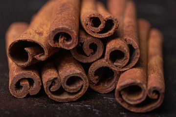 Cinnamon sticks on a dark background, close-up