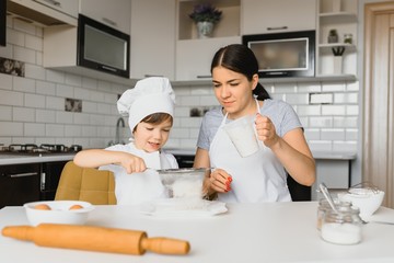 Happy family. Mother teaching her son how to cooking cake menu in morning. healthy lifestyle concept.. Baking Christmas cake and cook concept