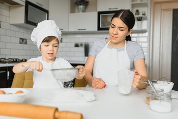 Happy family. Mother teaching her son how to cooking cake menu in morning. healthy lifestyle concept.. Baking Christmas cake and cook concept