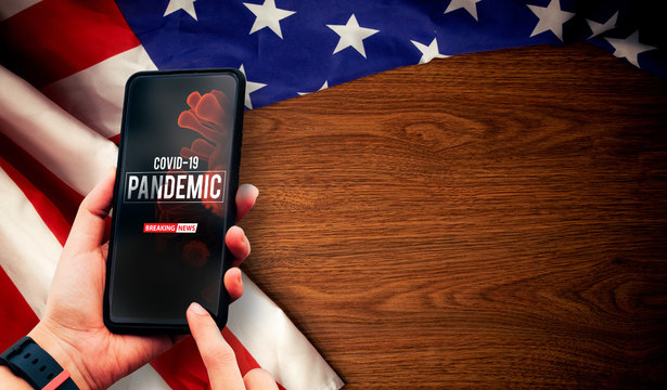 hand hold smartphone for news of blood dna nCov covid-19 structure coronavirus crisis outbreak pandemic biohazard cell atom disease syndrome on america flag