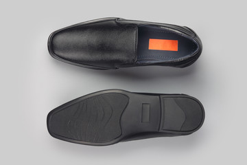 Black leather elegant shoes on gray background	
