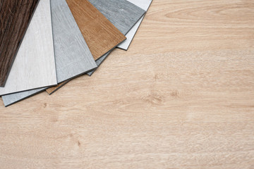 Sample catalog of luxury vinyl floor tiles with a new interior design for a house or floor on a...