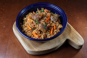 Rice with meat in a blue plate.