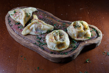 Dish Uzbek cuisine on a wooden stand.