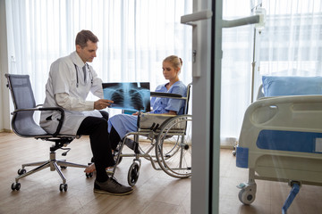 Doctor examining chest x-ray film of patient woman at hospital. Respiratory syndrome or viral pneumonia symptom concept