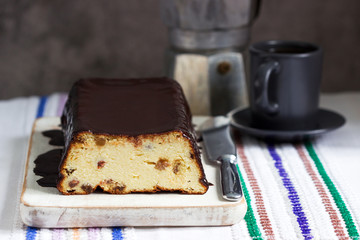 Lviv cheesecake, a traditional Ukrainian dessert with raisins, coated with chocolate icing.