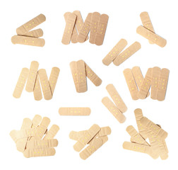 Set with sticking plasters on white background, top view