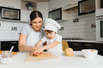 Happy mother and little son in the kitchen, happy time and togetherness
