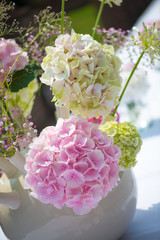 flowerdesign with pink and green hydrangeas in a natural setting