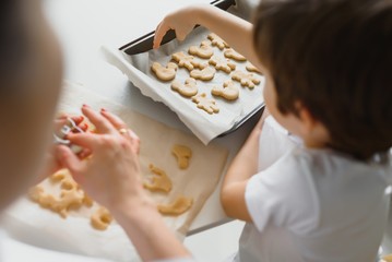 Happy mother and little son in the kitchen, happy time and togetherness