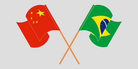 Crossed and waving flags of Brazil and China