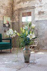 flower arrangement with white lilies in a industrial interior