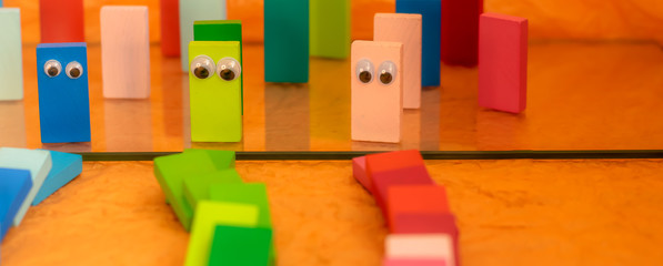 Toy dominos with eyes in a position of solidarity during the pandemic corona virus