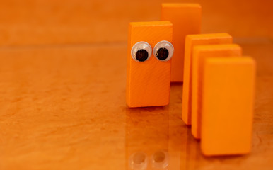 Toy dominos with eyes in a position of solidarity during the pandemic corona virus