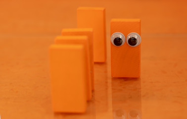 Toy dominos with eyes in a position of solidarity during the pandemic corona virus