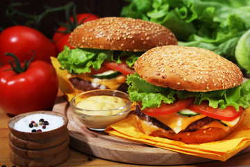 Two fresh hamburgers with vegetables