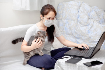 Work from home,studying,Creative space, concept. Business Asian Woman freelancers with assintant cat working on laptops and computers at home. People at home in quarantine to Virus Outbreak COVID-19
