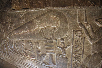 Mysterious murals on the walls of the Temple of Dendera Hathor , near the city of Ken. Electric...