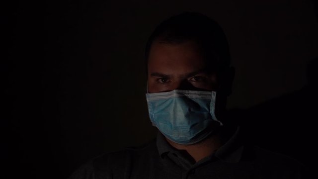 Man Wearing Medical Gloves And Mask On Dark Background. Coronavirus