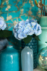blue vases with blue hydrangeasin a blue interior