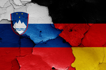 flags of Slovenia and Germany painted on cracked wall