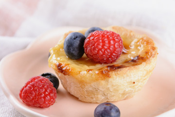 Puff pastry tartlet stuffed with creme brulee and fresh blueberries and raspberries