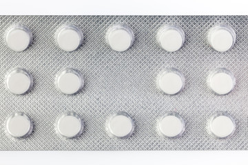Pile of tablets in blister packaging. Pharmaceutical industry. Pharmacy products. Health care . New blister with pills isolated on a white background.