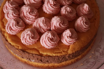 Colorful birthday cake with chocolate and pink cream toppings