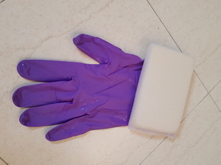 Closeup of rubber glove and sponge.  Household cleaning tool concept.