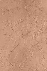 Abstract concrete wall texture for background. Color peach gelato. Copy space. Close-up.
