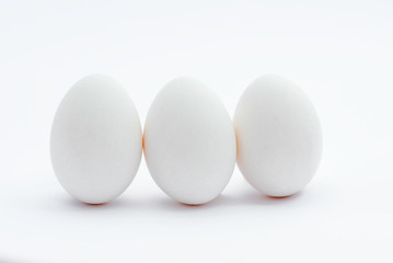 three white eggs isolated on white