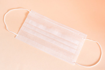 Mask to protect from the virus. Protective mask on an orange background.