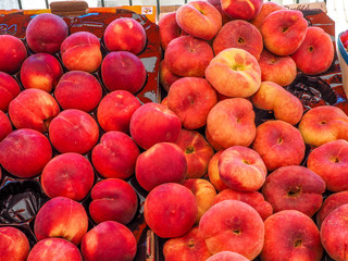 Fresh juicy peaches for sale at French fruit and vegetable market.