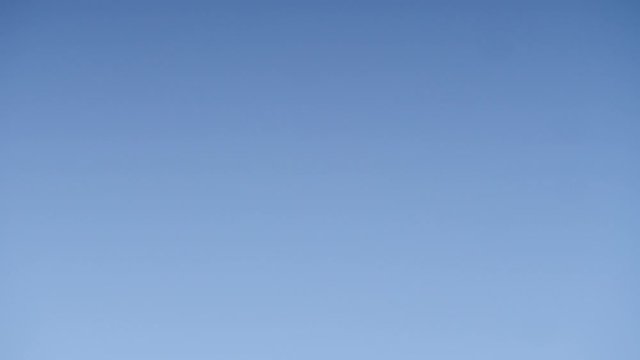 Paragliding. Extreme sport. Paraglider silhouette flying in the blue sky. Spain Alicante Santa Pola region