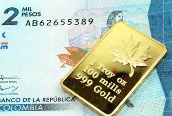 A macro image of a blue two thousand Colombian peso banknote with a gold bar.  Shot close up.