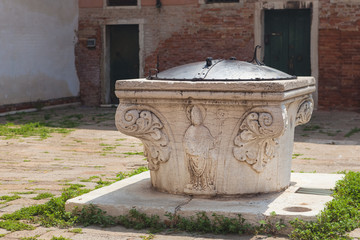 Ancient well at The Plaza del Orto in Venice, Italy