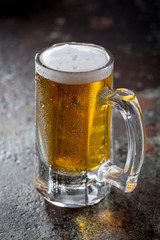 Light beer in a glass, on an old background.