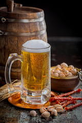 Light beer in a glass, on an old background.