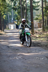 Fototapeta na wymiar off-road motorcycle trip in the forest, beautiful girl, feminism, sport, brutality, motorcyclist equipment, motorcycle driver, concept, active lifestyle, enduro