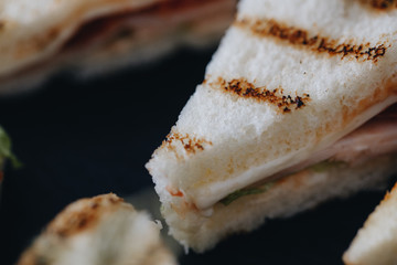 Beautifully decorated catering banquet table with different food snacks and appetizers with sandwich