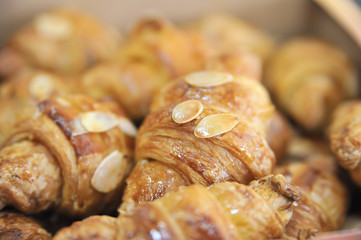 Croissant with almonds. Coffee desserts. Puff pastry with almonds. Delicious dessert with coffee cup.