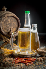 Light frothing beer in a glass, on an old background.