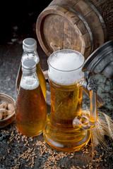Light frothing beer in a glass, on an old background.