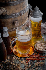 Light frothing beer in a glass, on an old background.