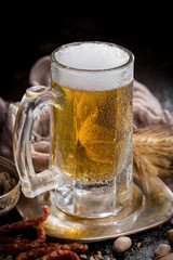 Light beer in a glass, on an old background.